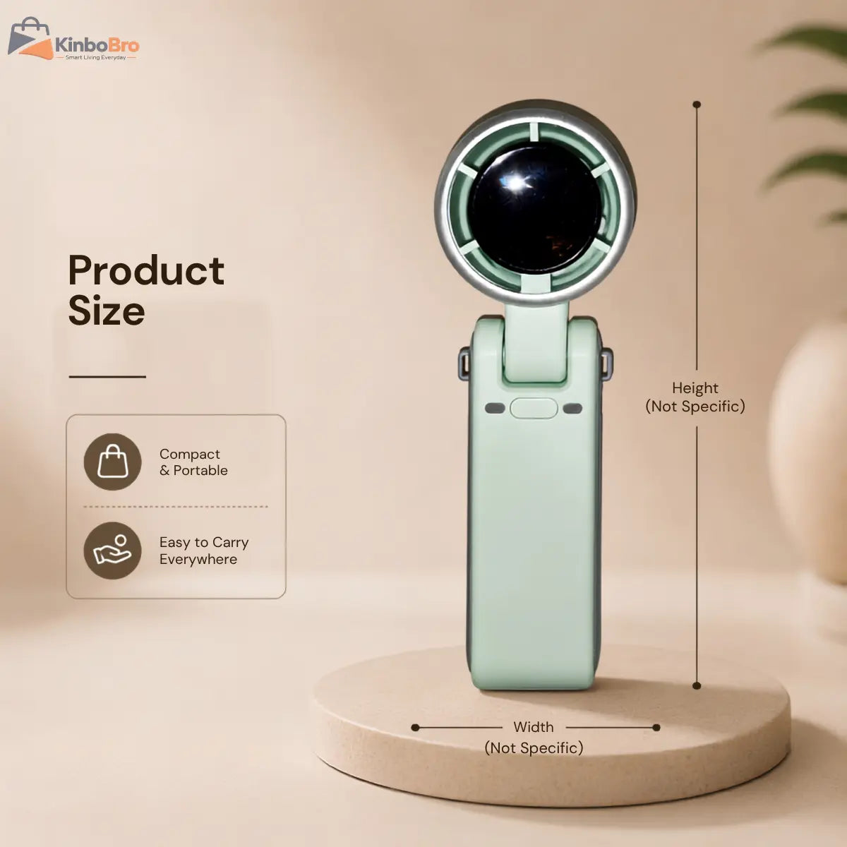 A compact handheld fan or mini fan shown on a round display base with overlaid product size annotations, including height and width, on a warm beige background. The product is mint green with a black circular front and silver trim.